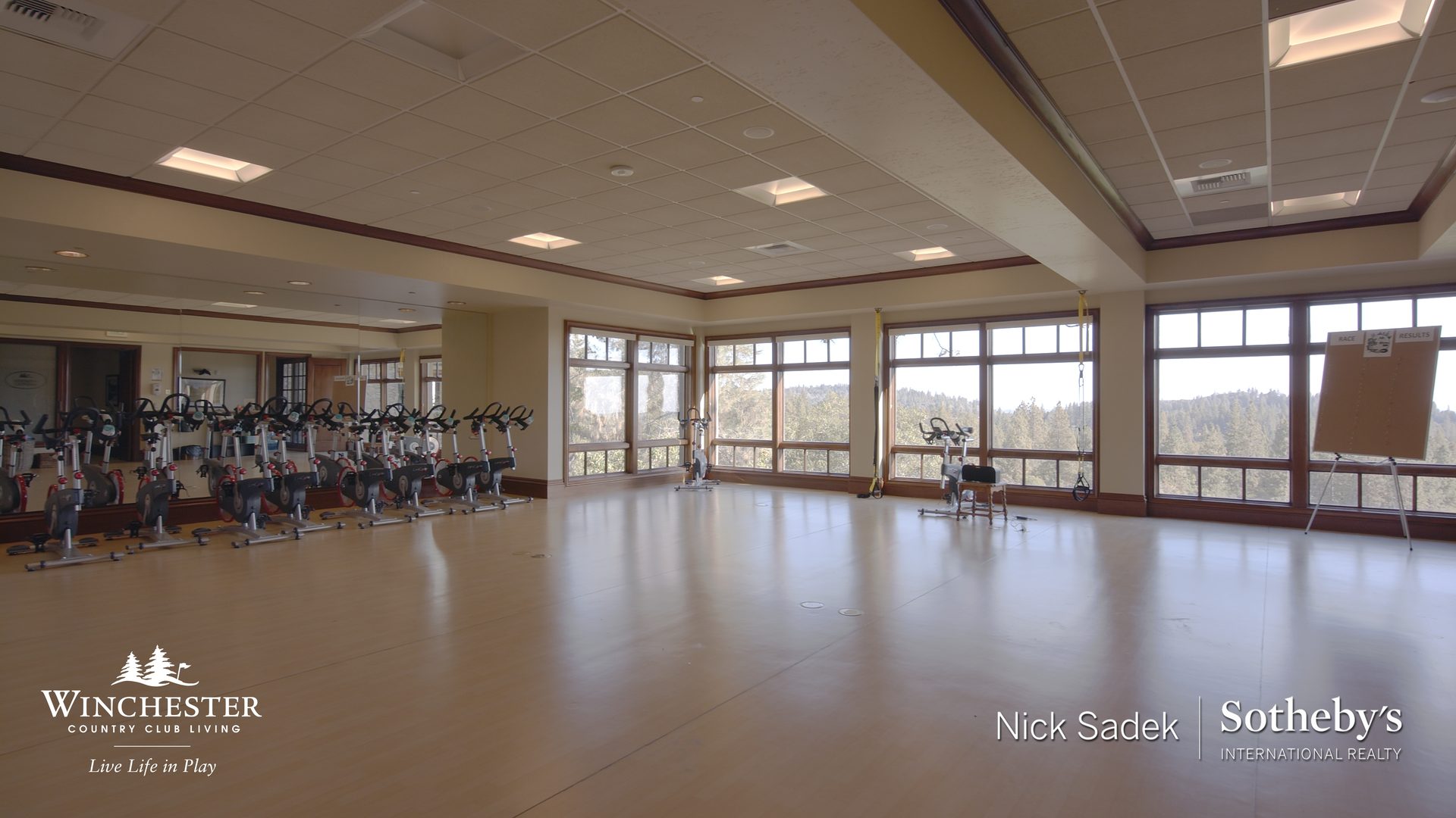 Fitness center with equipment and large windows
