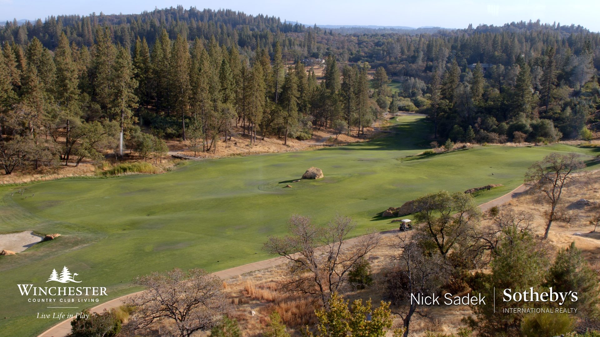 Championship golf fairway with mountain backdrop