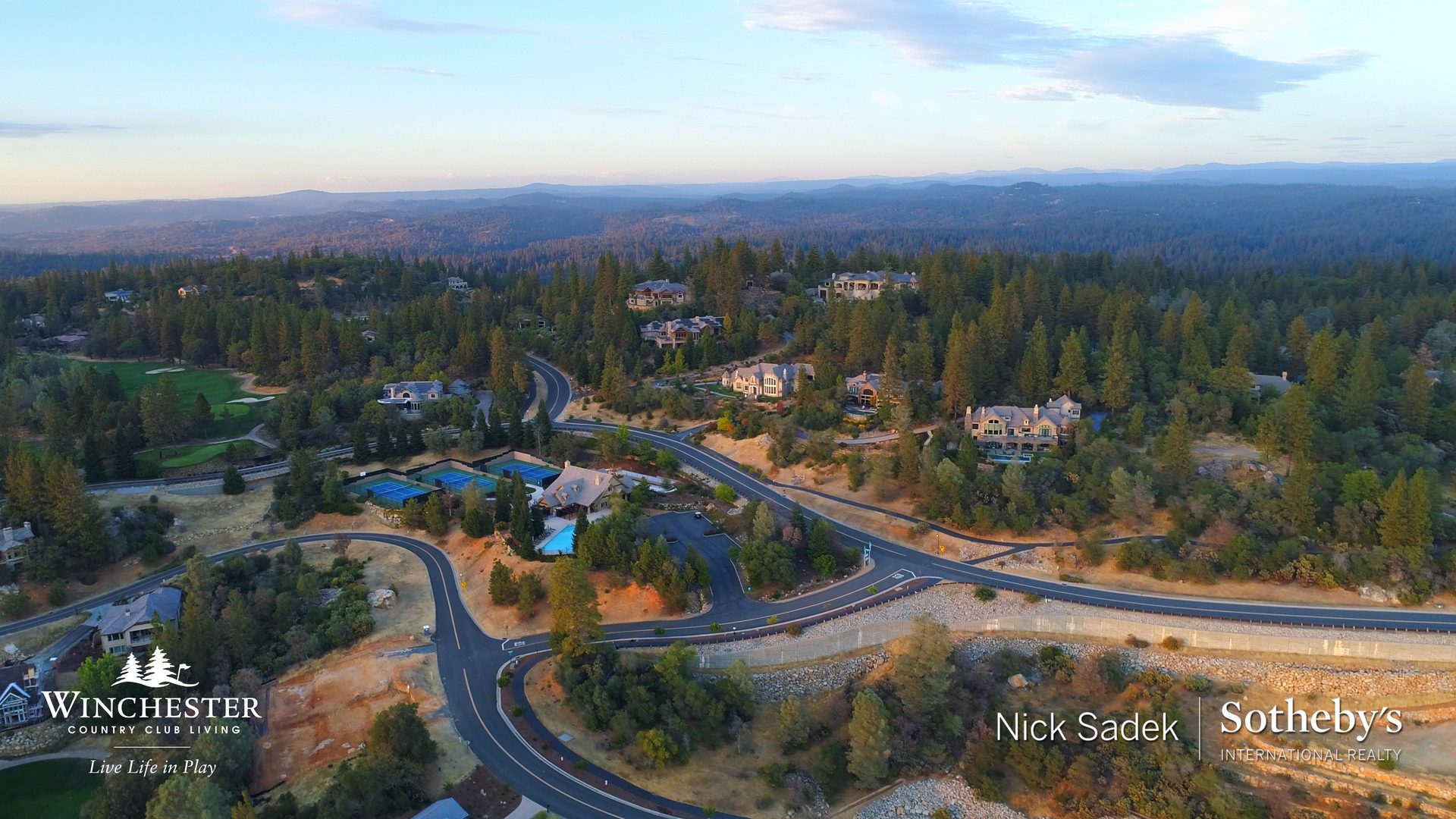 Aerial view showing tennis courts, pools, and homes