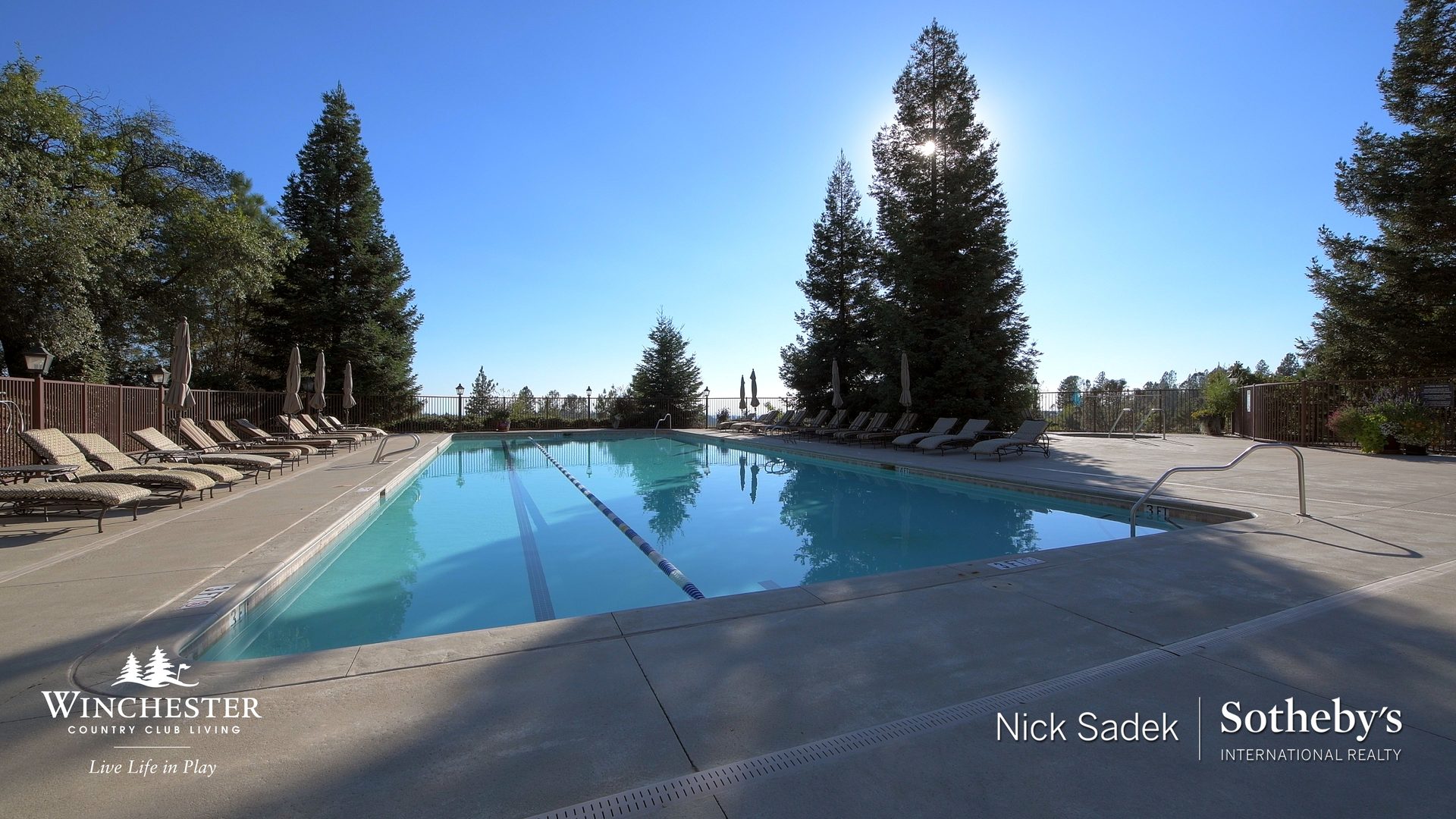 Resort-style swimming pool with lounge seating